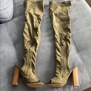 Knee high olive green boots.